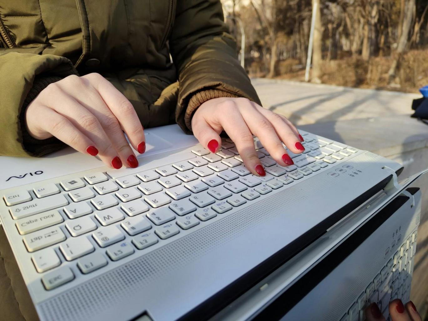 Modern business analysis workspace with multiple monitors displaying financial data and trend analysis